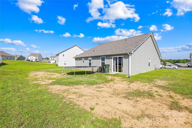 226 Caley St, Kings Mountain, NC 28086 - back of house with a trampoline, roof with shingles, a lawn, and a residential view