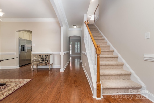 9836 Coatbridge Dr NW, Charlotte, NC 28269 - staircase with arched walkways, crown molding, and wood finished floors