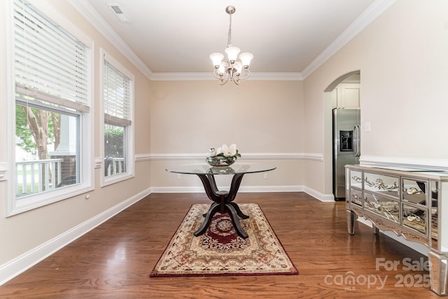 9836 Coatbridge Dr NW, Charlotte, NC 28269 - dining room with arched walkways, ornamental molding, dark wood-style flooring, and a chandelier