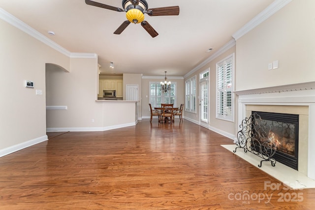 9836 Coatbridge Dr NW, Charlotte, NC 28269 - living area featuring a ceiling fan, wood finished floors, a fireplace, ornamental molding, and a chandelier