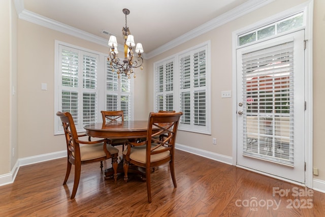 9836 Coatbridge Dr NW, Charlotte, NC 28269 - dining area with ornamental molding, a chandelier, and wood finished floors