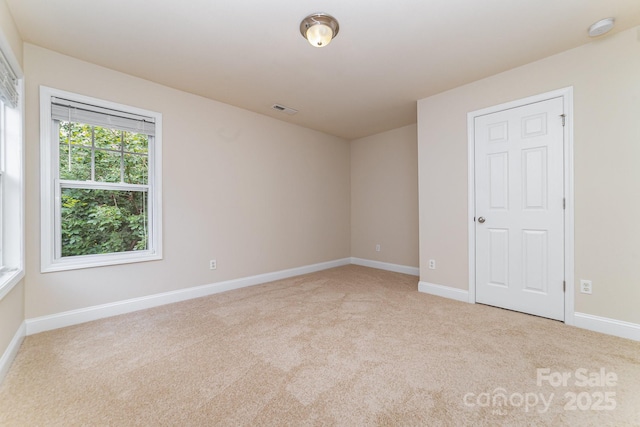 9836 Coatbridge Dr NW, Charlotte, NC 28269 - spare room featuring a smoke detector and light colored carpet