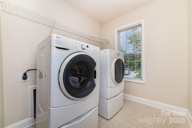 9836 Coatbridge Dr NW, Charlotte, NC 28269 - laundry room with washer and dryer and baseboards