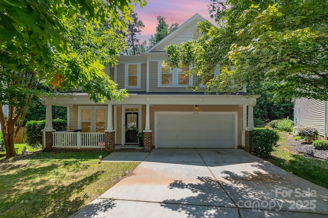 9836 Coatbridge Dr NW, Charlotte, NC 28269 - view of front of home with a porch, driveway, an attached garage, brick siding, and a lawn