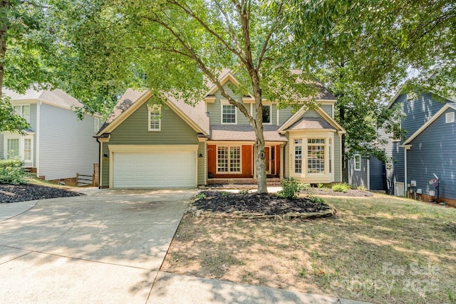 6225 Ash Cove Ln, Charlotte, NC 28269 - traditional-style house with concrete driveway, an attached garage, and a shingled roof
