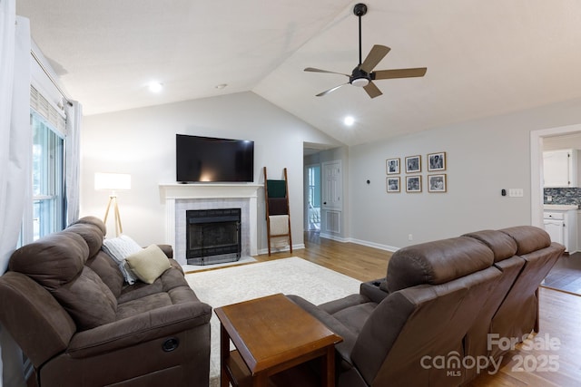 1631 Amanda Ln, Rock Hill, SC 29730 - living room with light wood-style flooring, ceiling fan, vaulted ceiling, a tiled fireplace, and recessed lighting