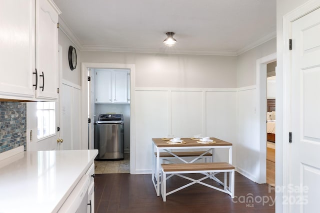 1631 Amanda Ln, Rock Hill, SC 29730 - kitchen featuring washer / clothes dryer, white cabinetry, dark wood-style flooring, a decorative wall, and wainscoting