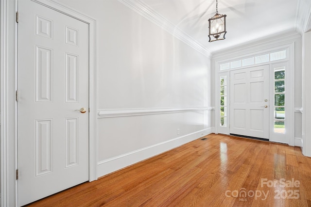 20308 Ridgebrook Ln, Locust, NC 28097 - entryway with light wood-style floors, crown molding, and a chandelier