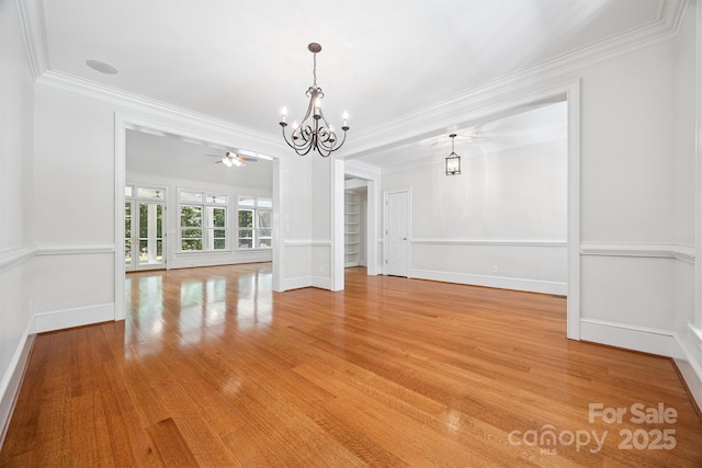 20308 Ridgebrook Ln, Locust, NC 28097 - unfurnished dining area with a chandelier, crown molding, light wood-style flooring, and a ceiling fan