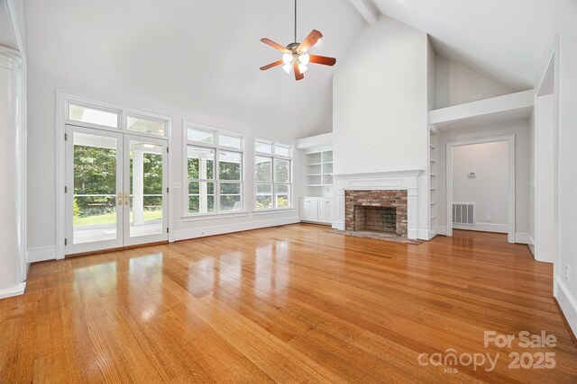 20308 Ridgebrook Ln, Locust, NC 28097 - unfurnished living room featuring high vaulted ceiling, ceiling fan, a brick fireplace, built in shelves, and wood finished floors