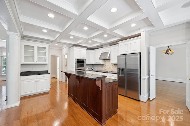 20308 Ridgebrook Ln, Locust, NC 28097 - kitchen with stainless steel appliances, a breakfast bar, light wood-style flooring, wall chimney exhaust hood, and beamed ceiling