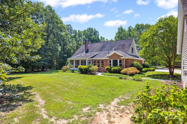 20308 Ridgebrook Ln, Locust, NC 28097 - view of front of home featuring brick siding, a front yard, a sunroom, and a chimney