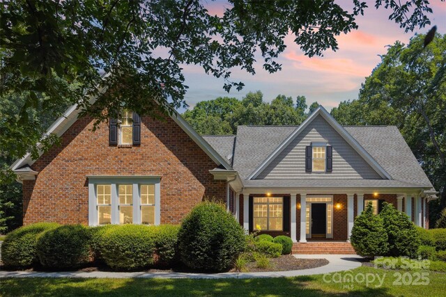 20308 Ridgebrook Ln, Locust, NC 28097 - view of front of home with brick siding, covered porch, and a shingled roof