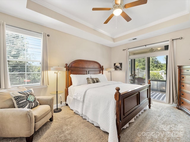 1313 Haywood Park Dr Unit 11, Waxhaw, NC 28173 - bedroom featuring access to exterior, multiple windows, a tray ceiling, crown molding, and light carpet