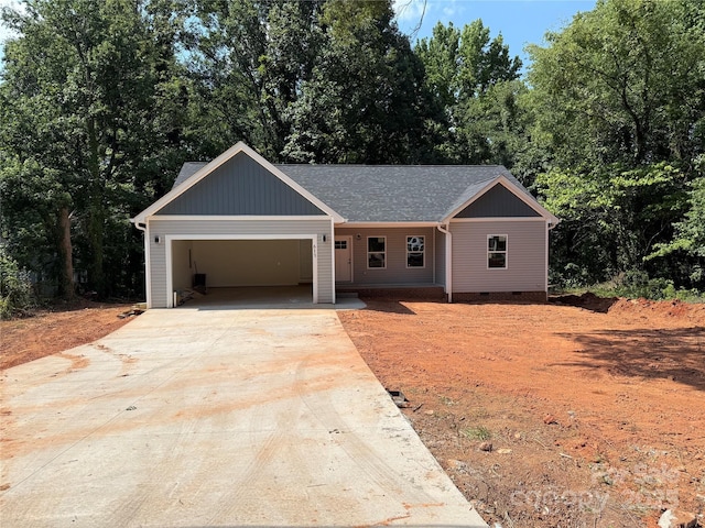 613 3rd Street Pl SW, Conover, NC 28613 - ranch-style house featuring driveway, a garage, crawl space, roof with shingles, and view of wooded area