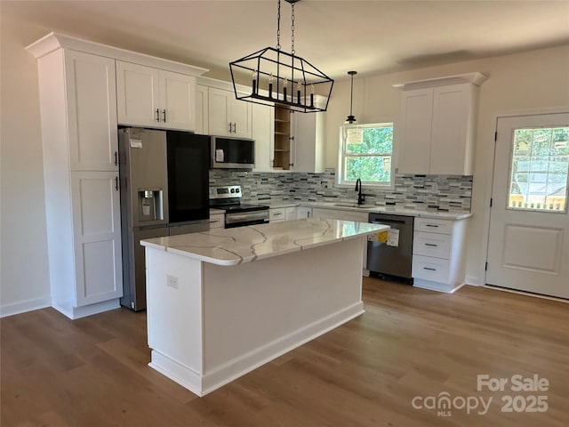 613 3rd Street Pl SW, Conover, NC 28613 - kitchen with stainless steel appliances, dark wood-style floors, white cabinets, and tasteful backsplash