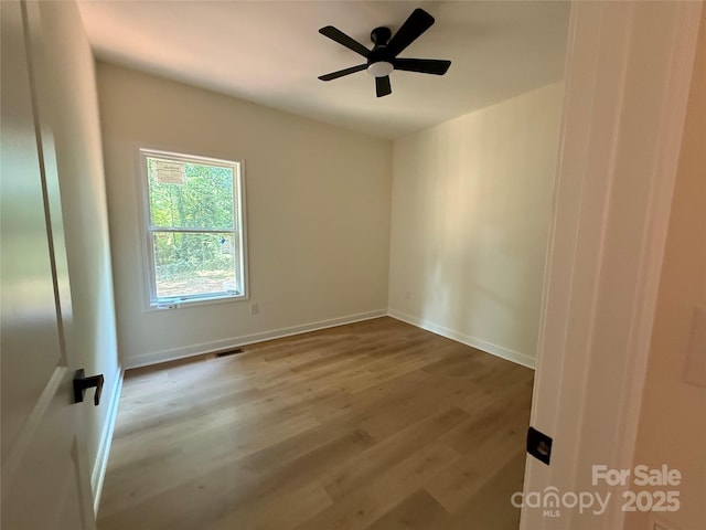 613 3rd Street Pl SW, Conover, NC 28613 - spare room featuring wood finished floors and ceiling fan