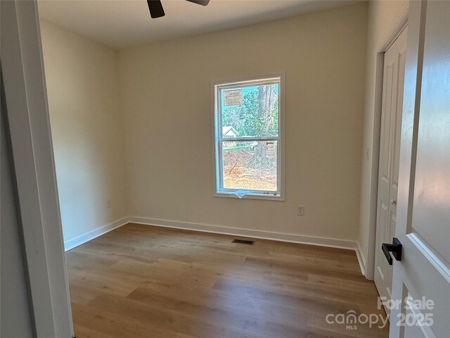 613 3rd Street Pl SW, Conover, NC 28613 - unfurnished room featuring wood finished floors and a ceiling fan