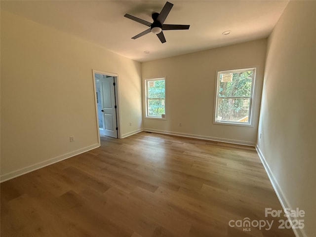 613 3rd Street Pl SW, Conover, NC 28613 - empty room featuring healthy amount of natural light, wood finished floors, and a ceiling fan