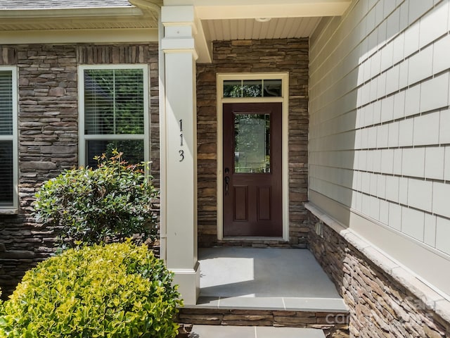 113 Chaska Loop, Troutman, NC 28166 - property entrance featuring stone siding and covered porch