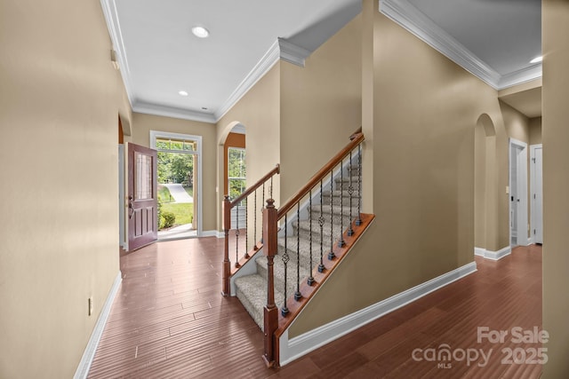 113 Chaska Loop, Troutman, NC 28166 - entryway featuring ornamental molding, arched walkways, wood finished floors, stairway, and recessed lighting