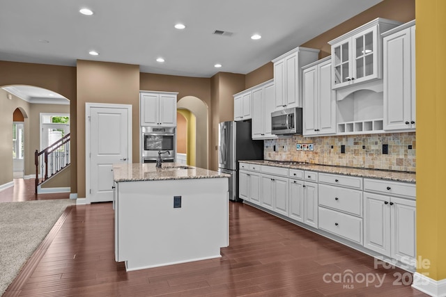 113 Chaska Loop, Troutman, NC 28166 - kitchen featuring appliances with stainless steel finishes, arched walkways, white cabinets, and recessed lighting