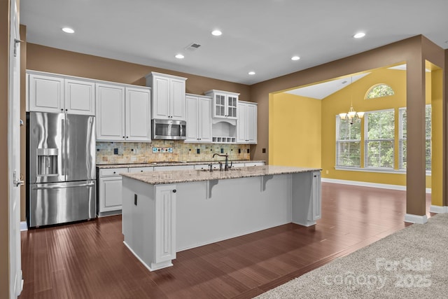 113 Chaska Loop, Troutman, NC 28166 - kitchen with stainless steel appliances, a chandelier, white cabinetry, lofted ceiling, and recessed lighting