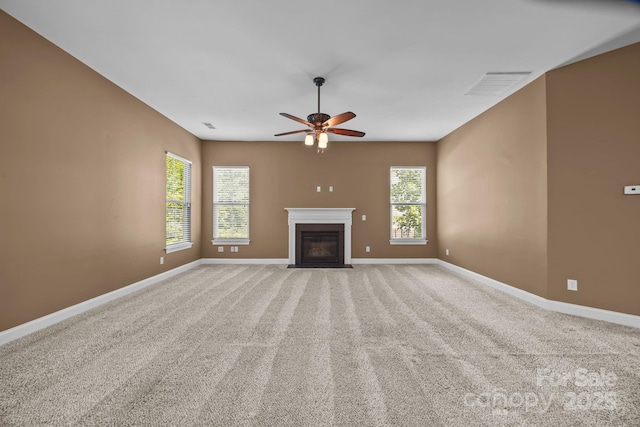 113 Chaska Loop, Troutman, NC 28166 - unfurnished living room featuring ceiling fan, a fireplace with flush hearth, and carpet floors
