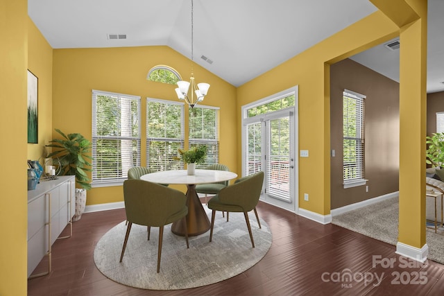 113 Chaska Loop, Troutman, NC 28166 - dining room featuring a chandelier, vaulted ceiling, and dark wood-style flooring
