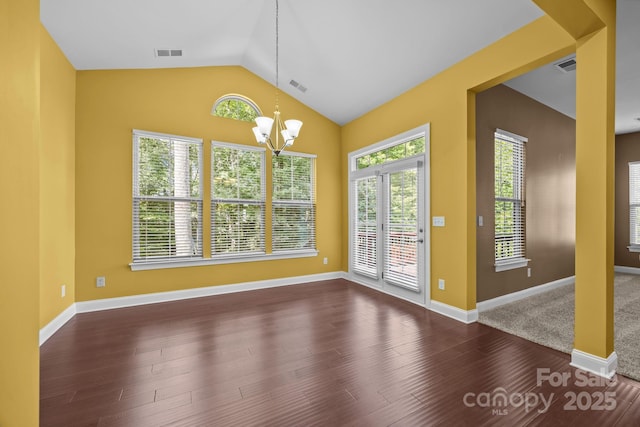 113 Chaska Loop, Troutman, NC 28166 - unfurnished dining area featuring a chandelier, dark wood-style flooring, and lofted ceiling