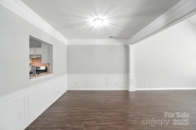 247 Aylesbury Ln, Indian Trail, NC 28079 - unfurnished room featuring a textured ceiling, dark wood-style floors, crown molding, and a wainscoted wall