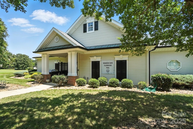247 Aylesbury Ln, Indian Trail, NC 28079 - view of front of house with a front lawn, covered porch, a standing seam roof, and a metal roof