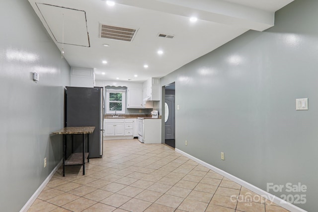 1416 Roy Dula Pl SW, Lenoir, NC 28645 - kitchen with freestanding refrigerator, stove, white cabinetry, recessed lighting, and light tile patterned flooring