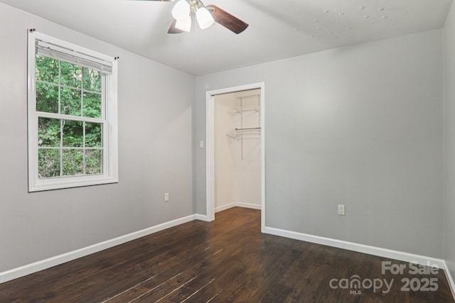 1416 Roy Dula Pl SW, Lenoir, NC 28645 - unfurnished bedroom with dark wood-style flooring, ceiling fan, and a spacious closet