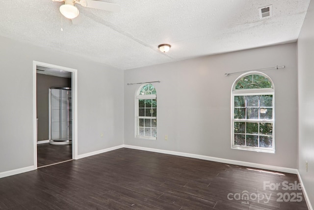 1416 Roy Dula Pl SW, Lenoir, NC 28645 - spare room with healthy amount of natural light, a textured ceiling, wood finished floors, and ceiling fan
