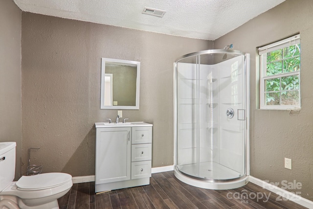 1416 Roy Dula Pl SW, Lenoir, NC 28645 - bathroom featuring wood finished floors, a stall shower, a textured wall, vanity, and a textured ceiling