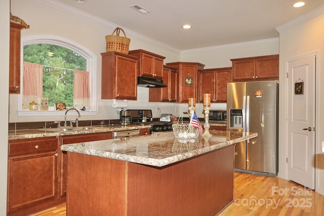 485 Calloway Rd, Lowgap, NC 27024 - kitchen featuring stainless steel appliances, under cabinet range hood, light wood-type flooring, light stone countertops, and a center island
