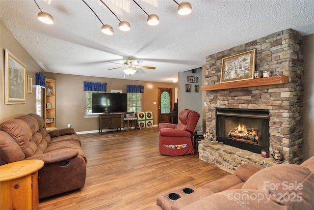 3149 Simmons St, Kannapolis, NC 28083 - living area featuring a textured ceiling, a fireplace, ceiling fan, and wood finished floors