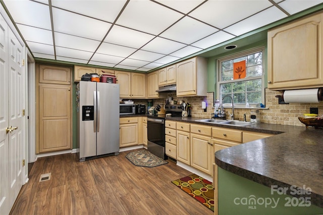 3149 Simmons St, Kannapolis, NC 28083 - kitchen with appliances with stainless steel finishes, under cabinet range hood, dark countertops, light brown cabinets, and dark wood-type flooring