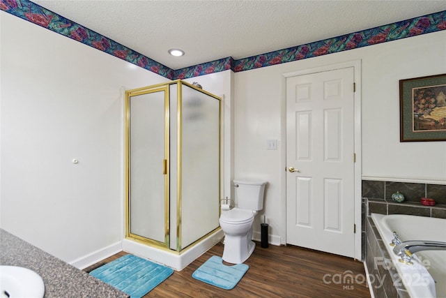3149 Simmons St, Kannapolis, NC 28083 - bathroom with a shower stall, a garden tub, wood finished floors, a textured ceiling, and vanity