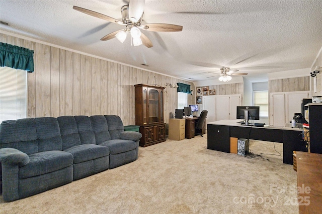 3149 Simmons St, Kannapolis, NC 28083 - living room featuring a desk, ceiling fan, crown molding, light colored carpet, and wooden walls