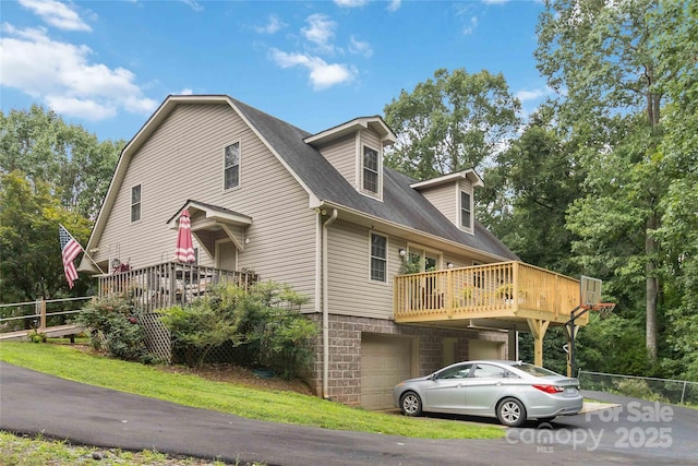 3149 Simmons St, Kannapolis, NC 28083 - view of home's exterior with an attached garage, a wooden deck, a shingled roof, and driveway