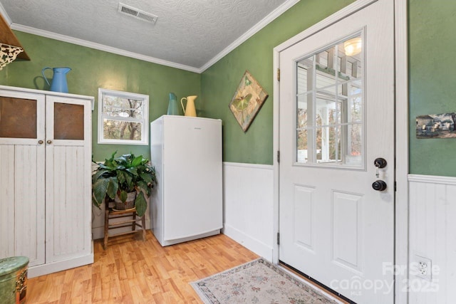 2633 Jb Denton Rd, Lancaster, SC 29720 - entryway featuring light wood finished floors, wainscoting, ornamental molding, and a textured ceiling