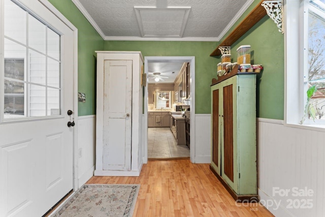 2633 Jb Denton Rd, Lancaster, SC 29720 - entryway featuring wainscoting, light wood-type flooring, a textured ceiling, and ornamental molding