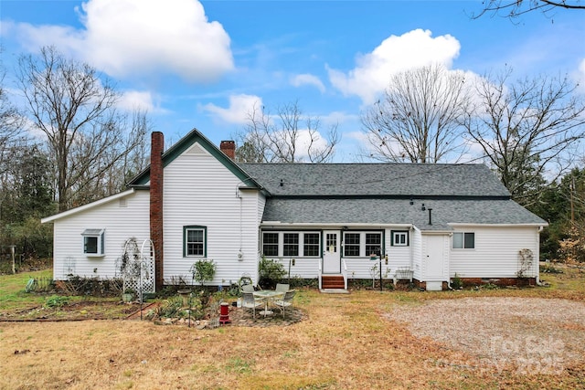 2633 Jb Denton Rd, Lancaster, SC 29720 - rear view of property with entry steps, roof with shingles, a chimney, and a lawn