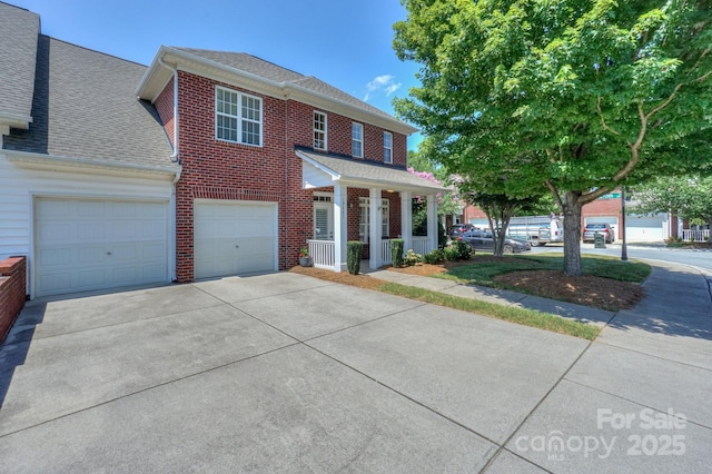 19421 Beaufain St, Cornelius, NC 28031 - view of front of house with driveway, brick siding, a porch, a shingled roof, and an attached garage