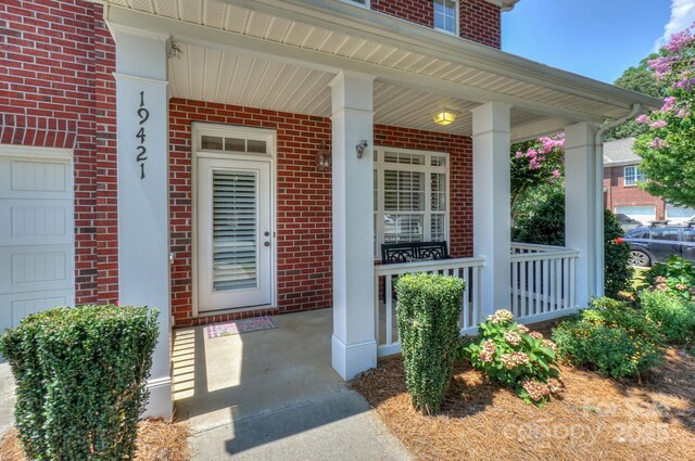 19421 Beaufain St, Cornelius, NC 28031 - doorway to property with brick siding and covered porch