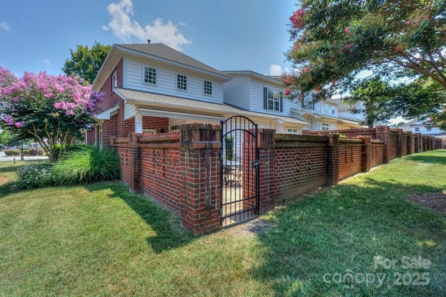 19421 Beaufain St, Cornelius, NC 28031 - rear view of property featuring a fenced front yard, a gate, brick siding, and a shingled roof