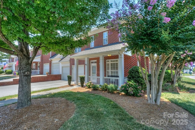 19421 Beaufain St, Cornelius, NC 28031 - view of front of property featuring brick siding, a porch, driveway, and an attached garage