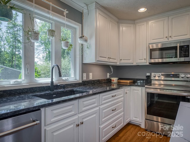 7376 NC-181 Hwy, Morganton, NC 28655 - kitchen featuring stainless steel appliances, white cabinets, recessed lighting, and a textured ceiling